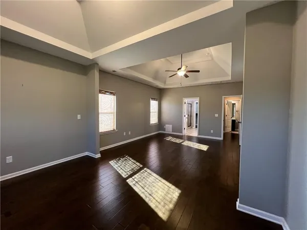 a view of room with window and wooden floor