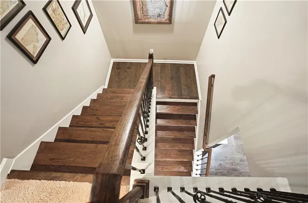 a bedroom with a bed dresser and a chandelier