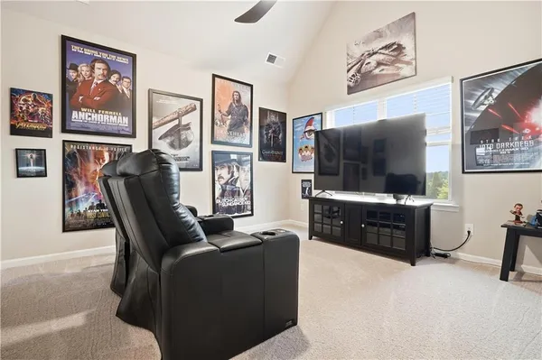 a living room with furniture and a painting on the wall