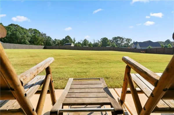 a view of a lake with a table and chairs