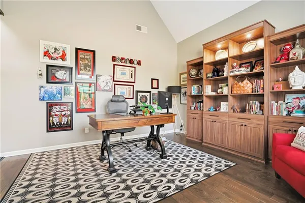 a living room with furniture a rug and a bookshelf