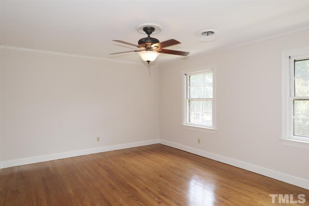 6709 Foxfire Place Raleigh, NC 27615 - Photo 20 of 24 a view of empty room with wooden floor and fan