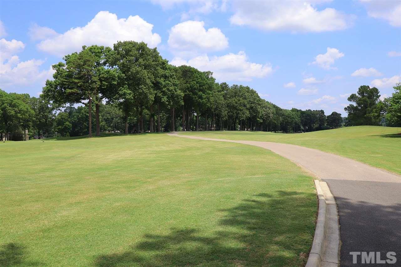 6709 Foxfire Place Raleigh, NC 27615 - Photo 24 of 24 a view of a golf course with a lake