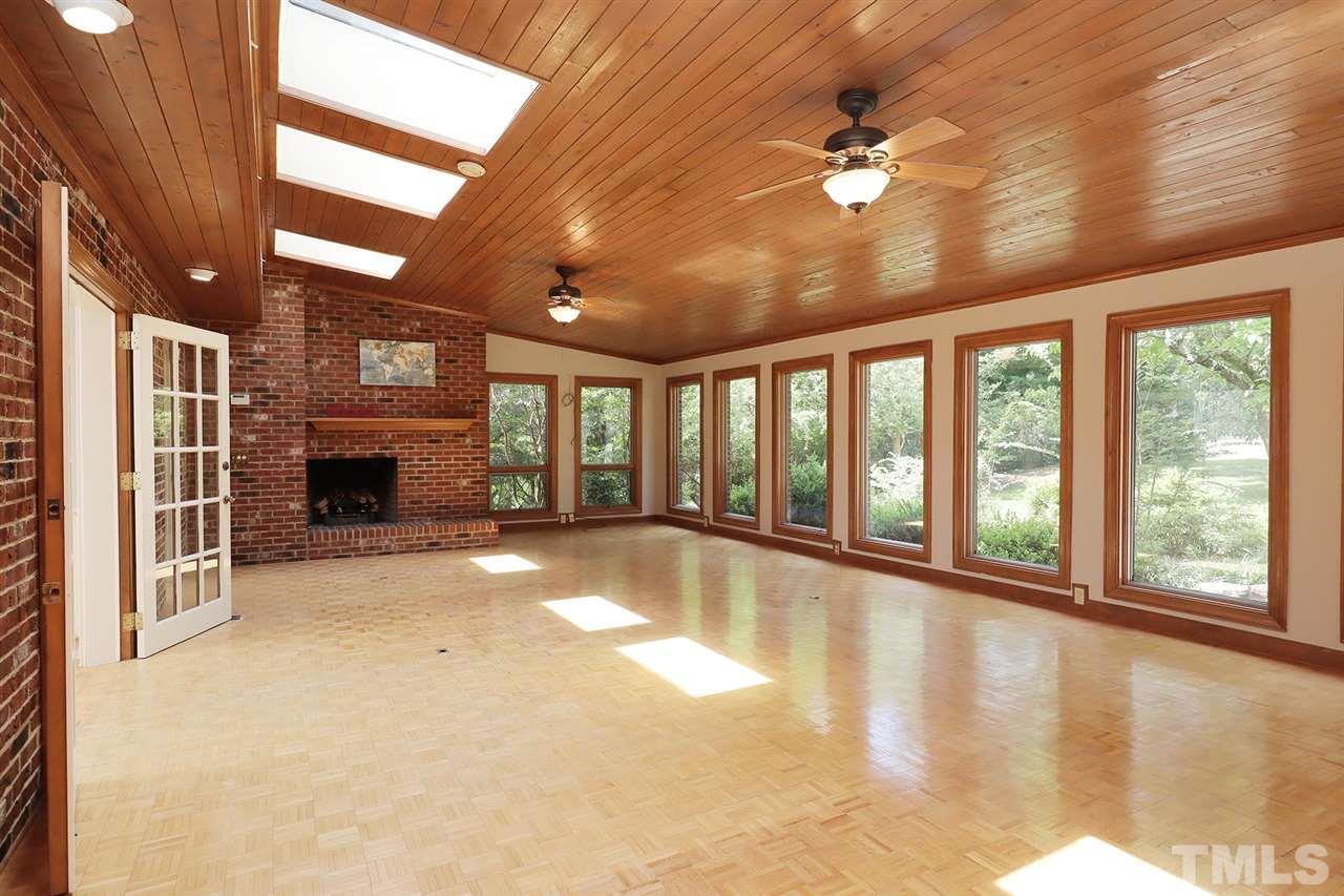 6709 Foxfire Place Raleigh, NC 27615 - Photo 10 of 24 a view of an empty room with a fireplace and a window