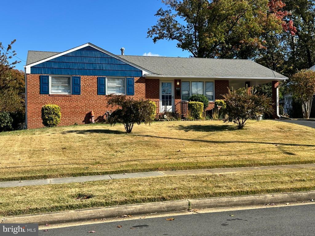 a front view of a house with a yard table and chairs