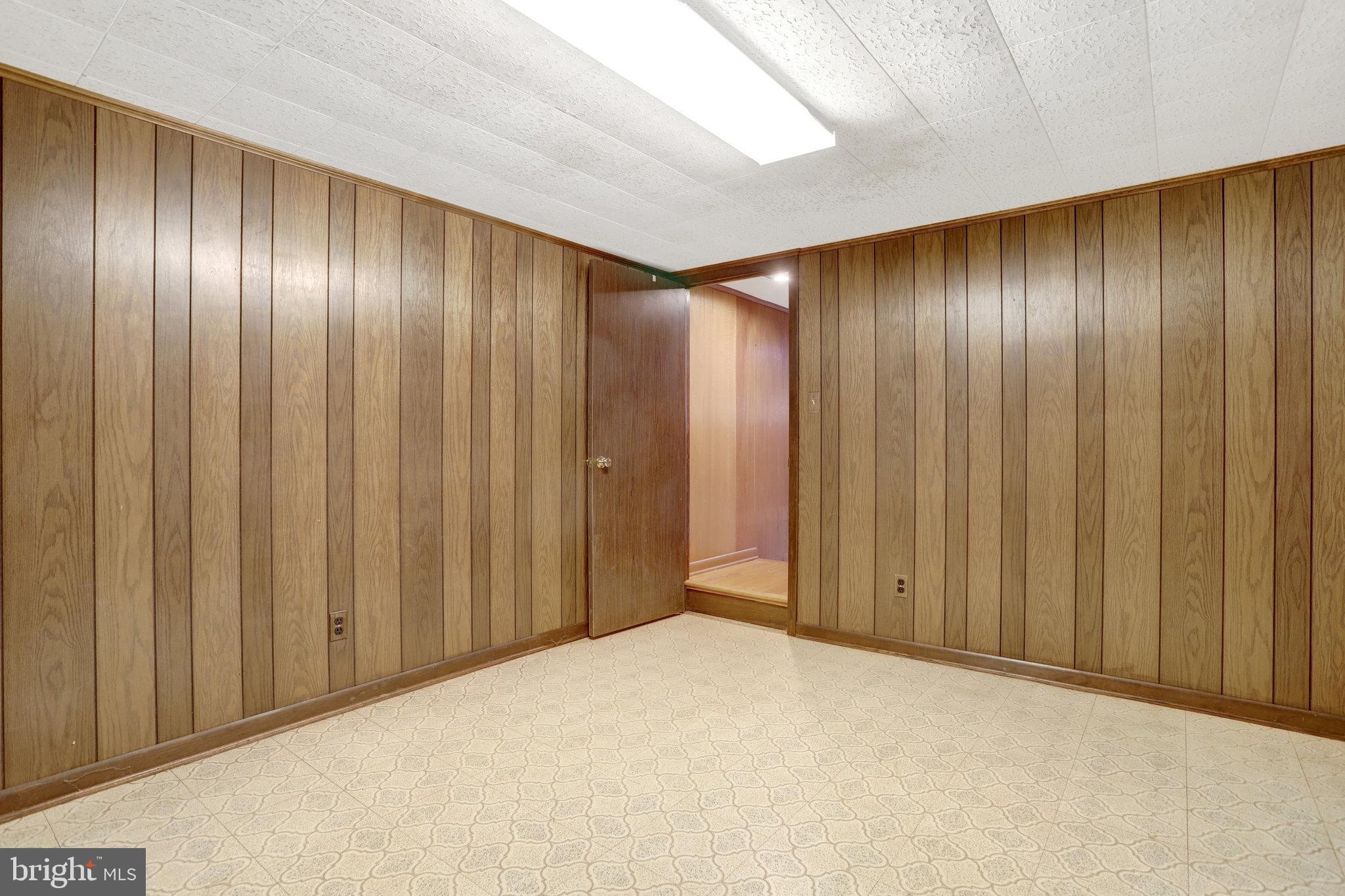 6928 Ruskin Street Springfield, VA 22150 - Photo 22 of 34 a view of an empty room with wooden walls