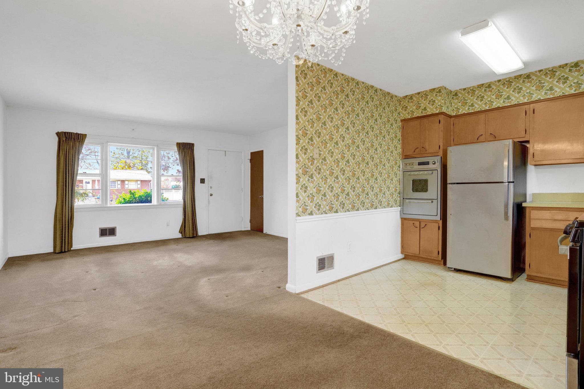 6928 Ruskin Street Springfield, VA 22150 - Photo 7 of 34 a view of an empty room with a kitchen