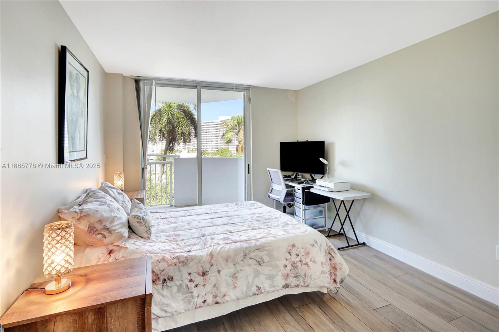 1621 Bay Road, Unit 506 Miami Beach, FL 33139 - Photo 11 of 26 a bedroom with a bed and a flat screen tv