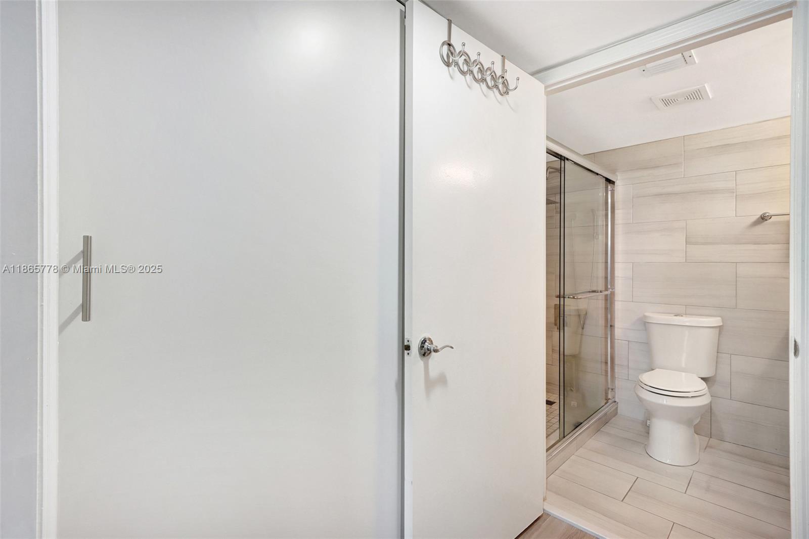 1621 Bay Road, Unit 506 Miami Beach, FL 33139 - Photo 13 of 26 a bathroom with a shower and a toilet