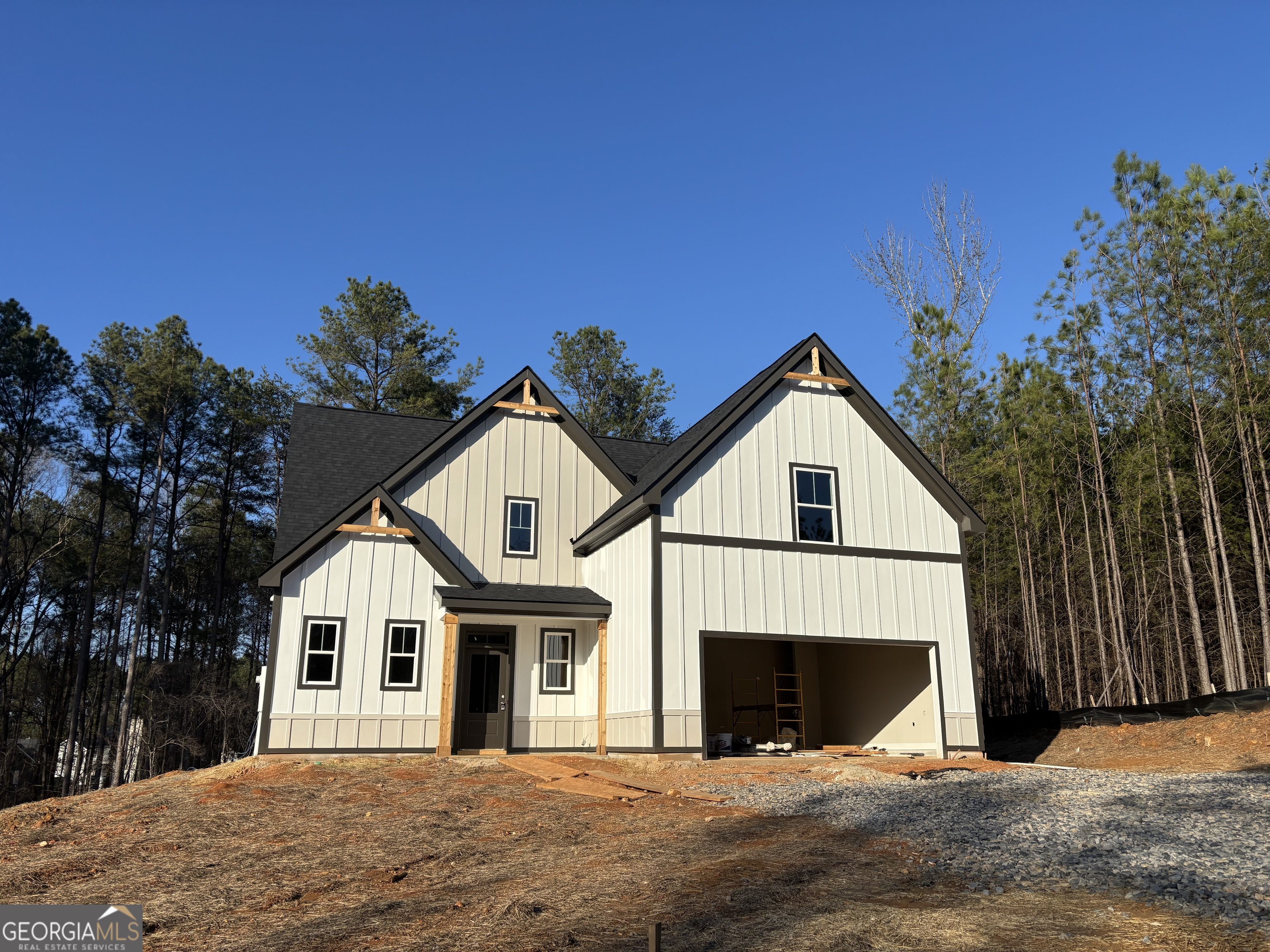 a view of a house with a yard and large tree