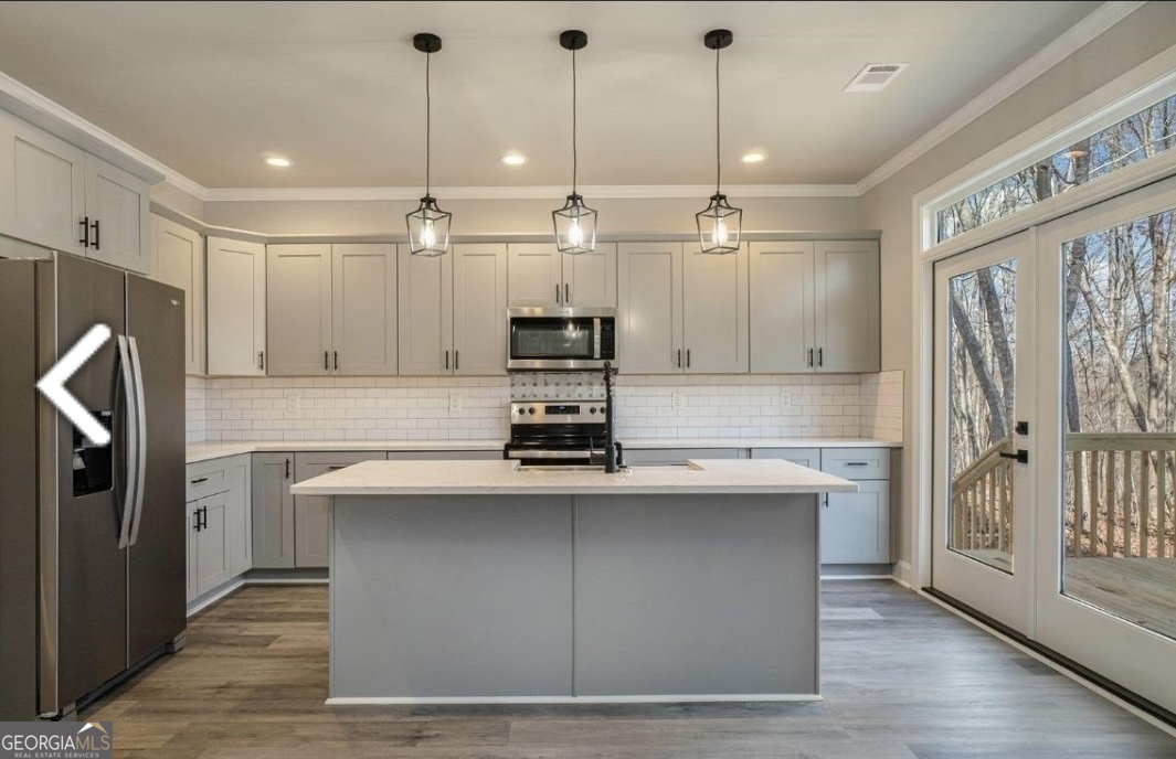 16 Hadrian Ridge Drive Southwest Rome, GA 30165 - Photo 11 of 25 a kitchen with kitchen island a sink stainless steel appliances and cabinets