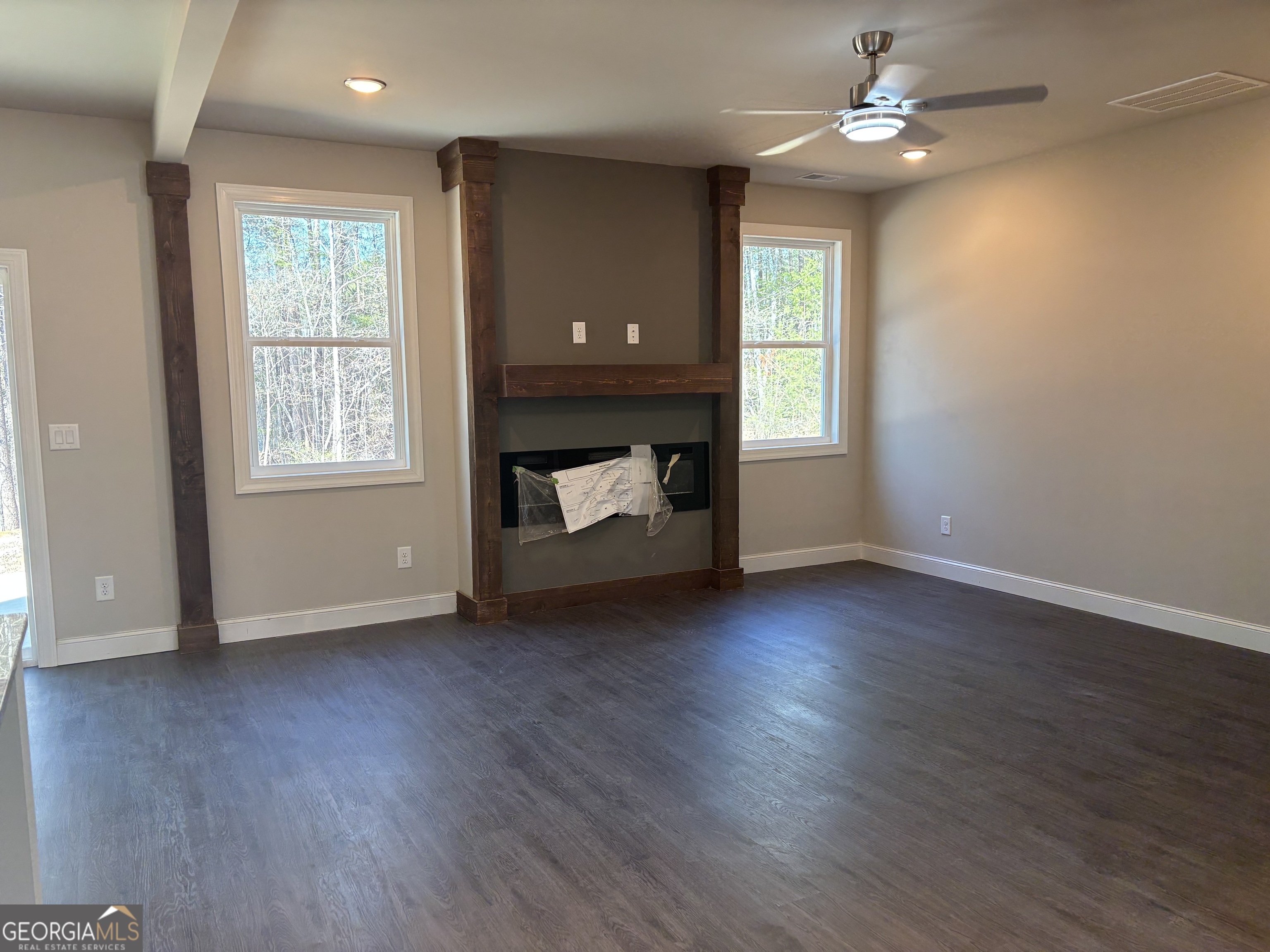 16 Hadrian Ridge Drive Southwest Rome, GA 30165 - Photo 15 of 25 an empty room with wooden floor fireplace and windows