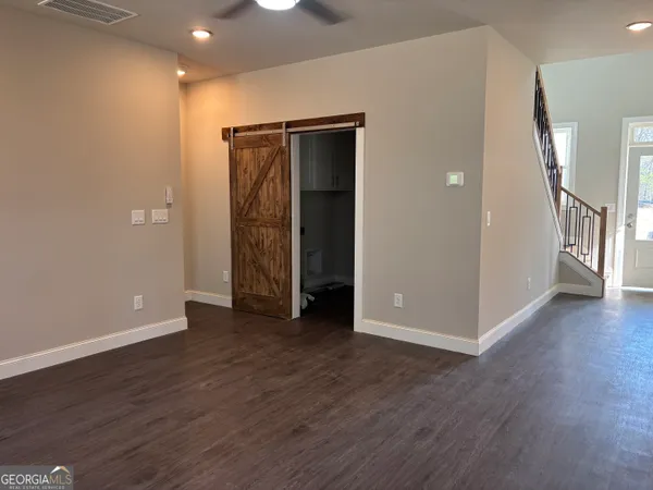 an empty room with wooden floor and a window