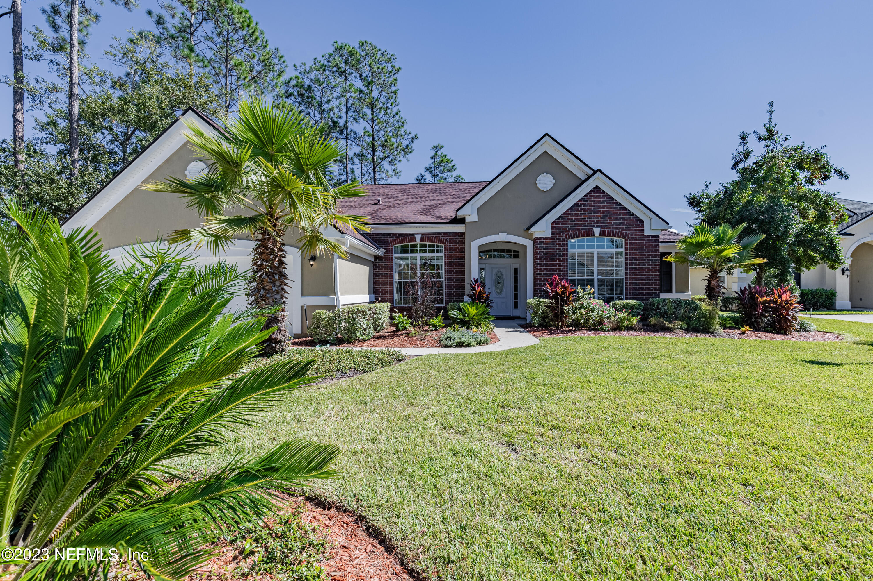 800 Eagle Cove Drive Fleming Island, FL 32003 - Photo 1 of 99 a front view of a house with a yard