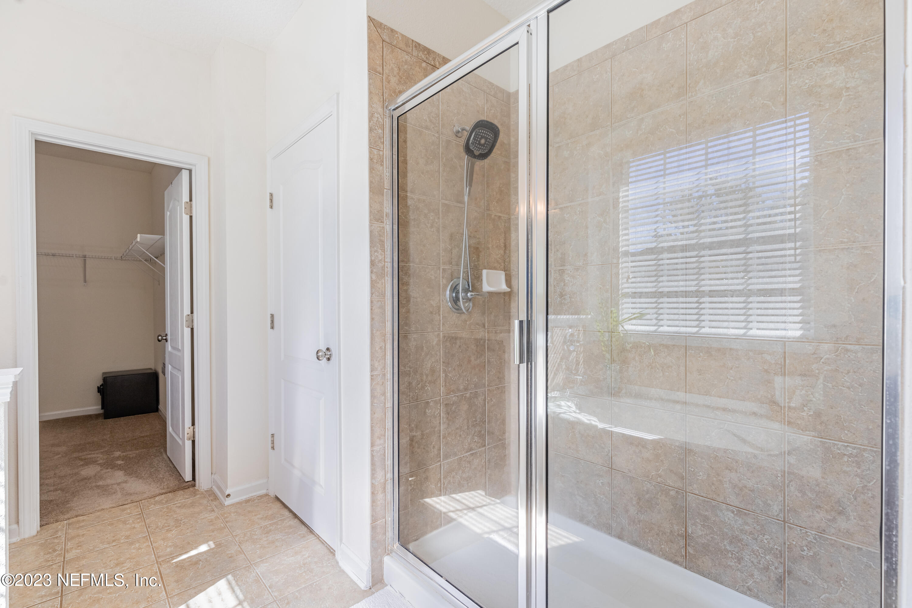 800 Eagle Cove Drive Fleming Island, FL 32003 - Photo 16 of 99 a bathroom with a glass shower door