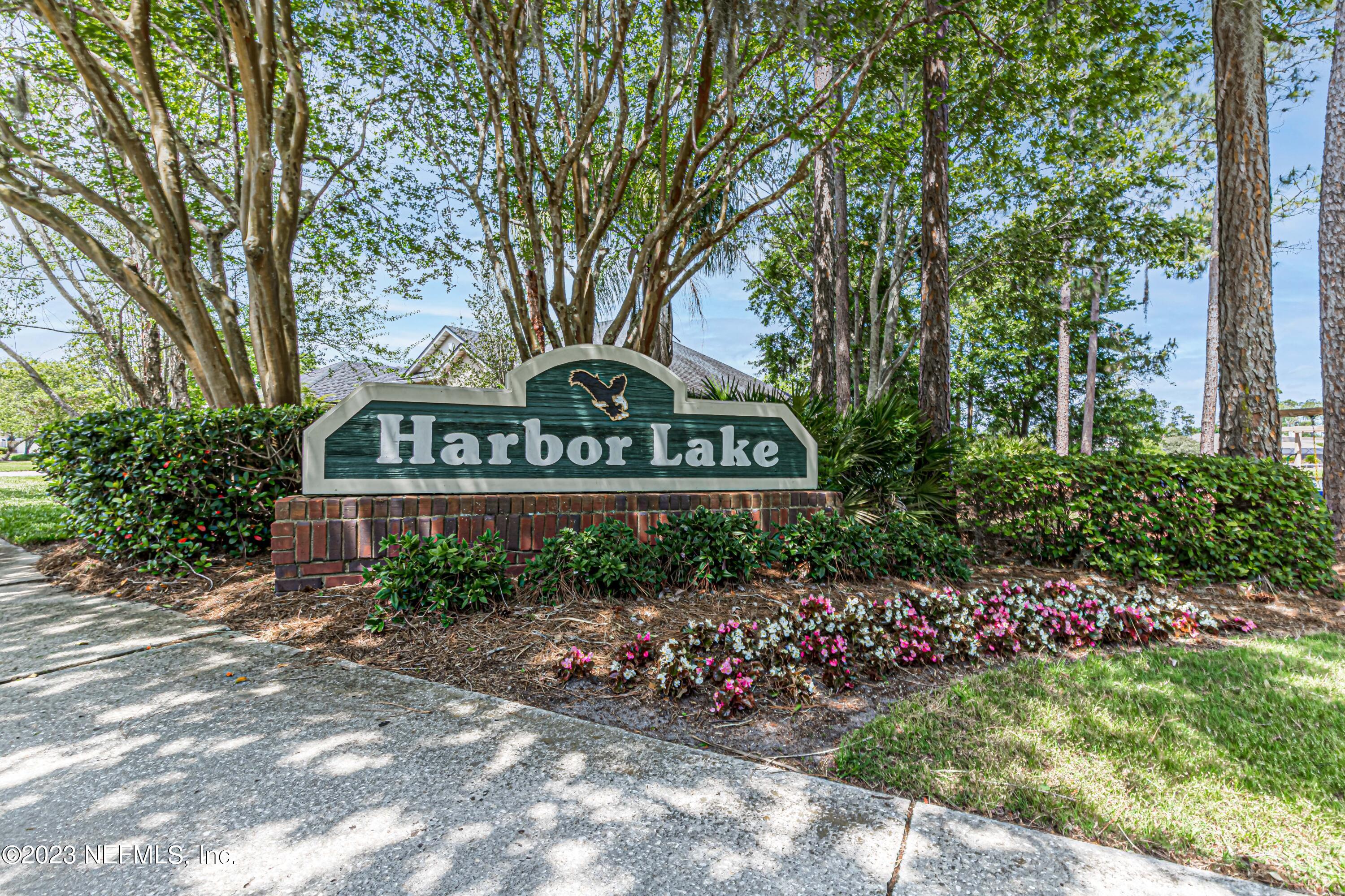 800 Eagle Cove Drive Fleming Island, FL 32003 - Photo 56 of 99 a view of sign board with flower plants