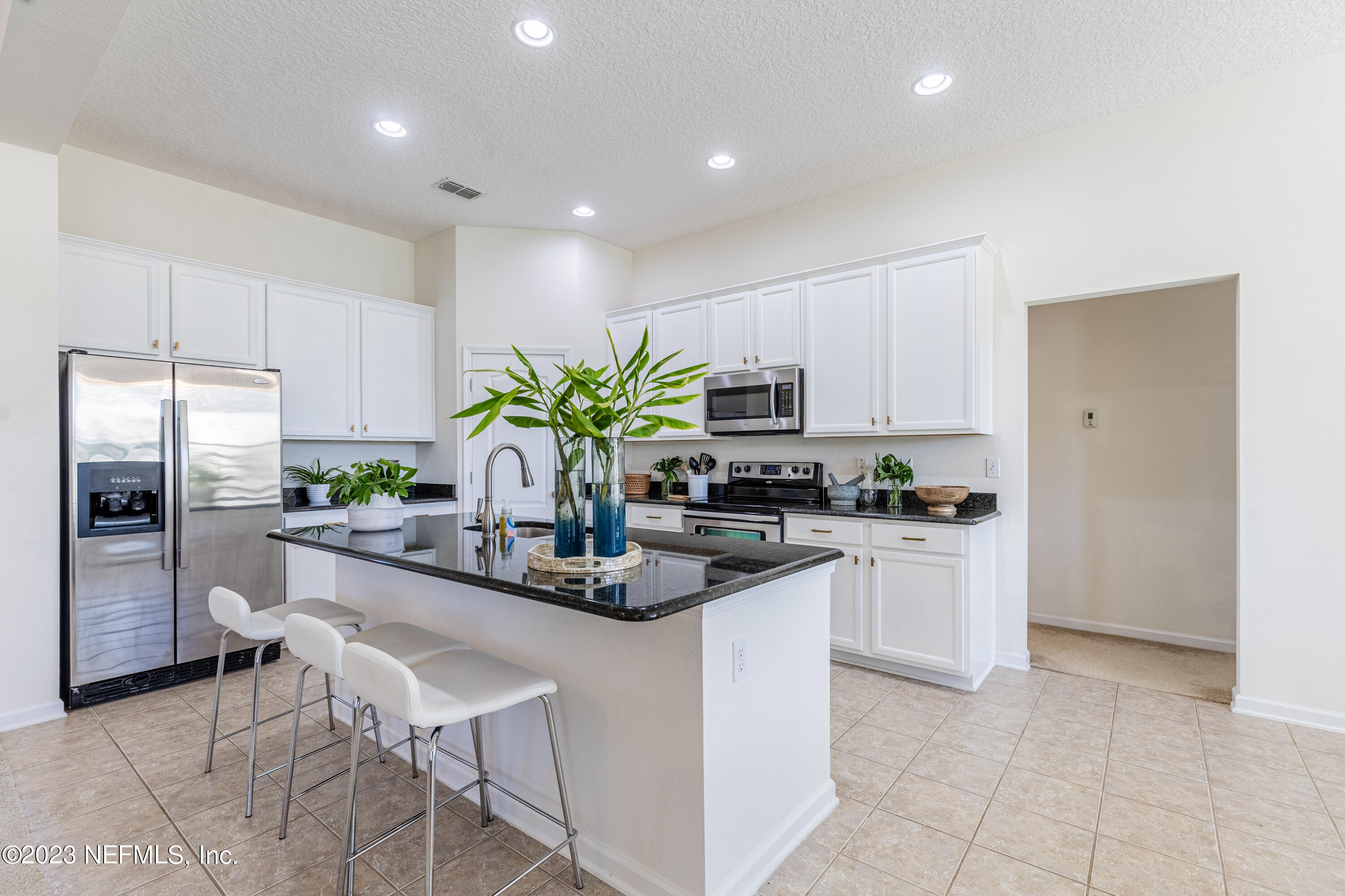 800 Eagle Cove Drive Fleming Island, FL 32003 - Photo 6 of 99 a kitchen with stainless steel appliances kitchen island granite countertop a refrigerator and a sink