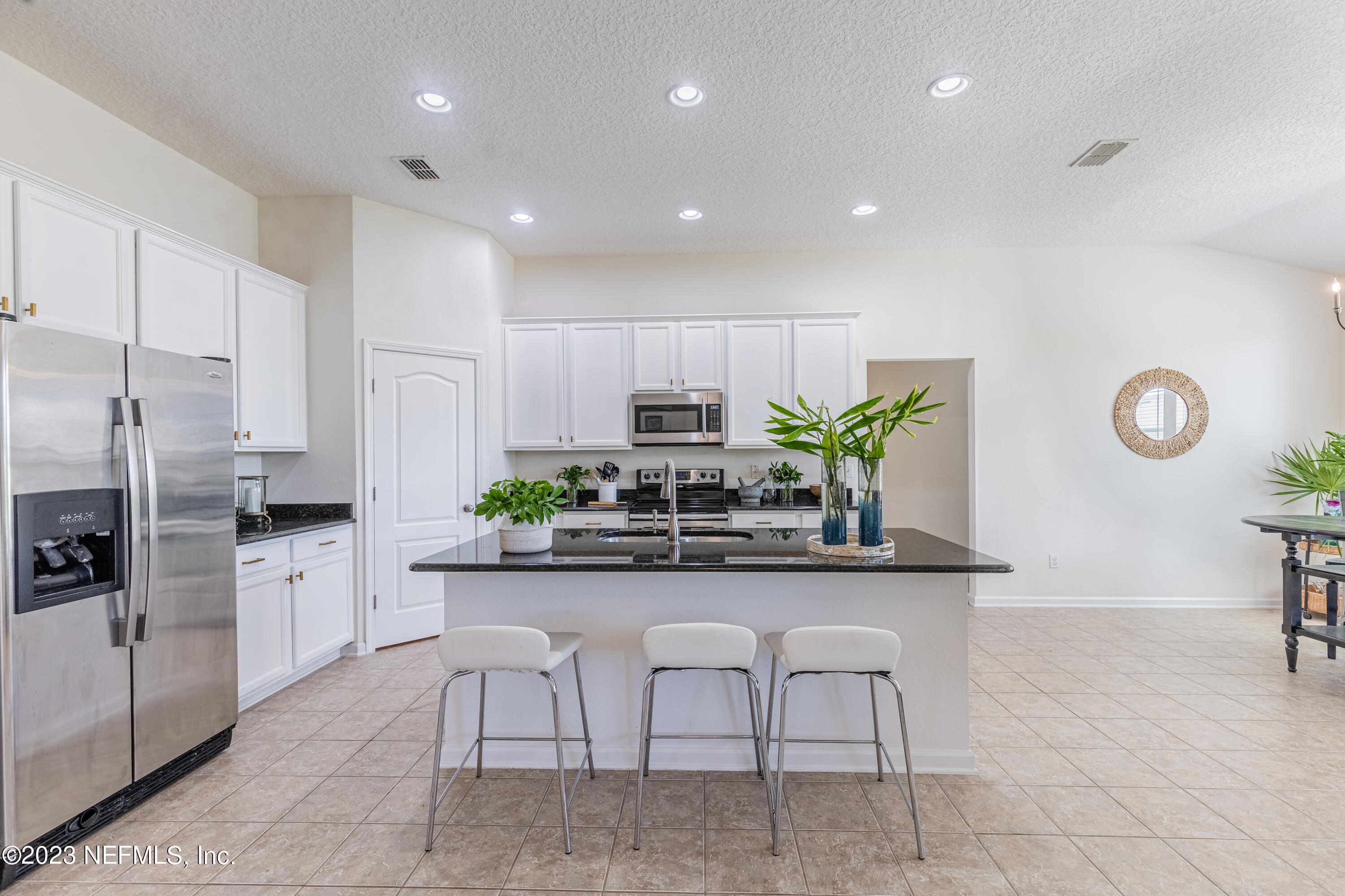800 Eagle Cove Drive Fleming Island, FL 32003 - Photo 7 of 99 a kitchen with stainless steel appliances granite countertop a table and chairs in it