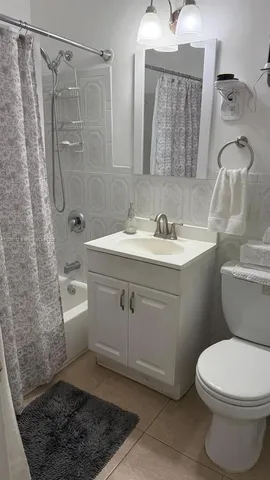 a backyard of a house with barbeque oven table and chairs