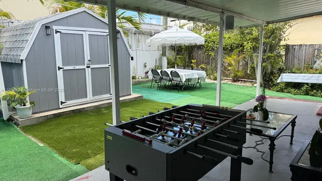 a view of an chairs in the backyard