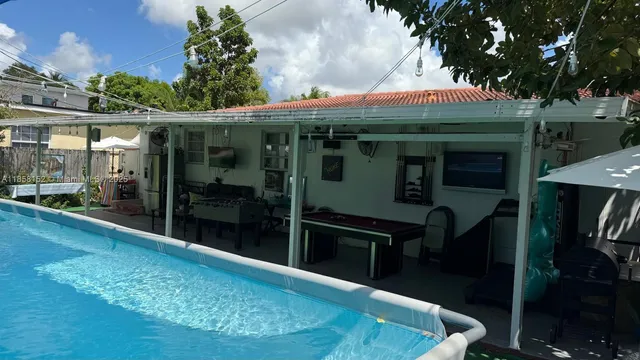 a swimming pool with outdoor seating and yard