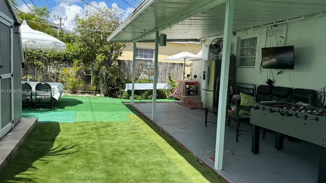 a backyard of a house with table and chairs