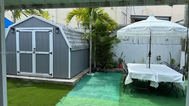 a view of a backyard with sitting area