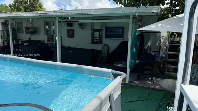 a view of a backyard with plants and a patio