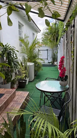 a bedroom with a bed closet and a flat tv screen