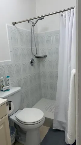 a bedroom with a bed and ceiling fan