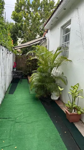 a white toilet sitting next to a white sink and a shower curtain