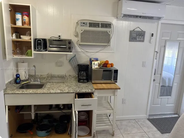 a kitchen with a sink appliances and cabinets
