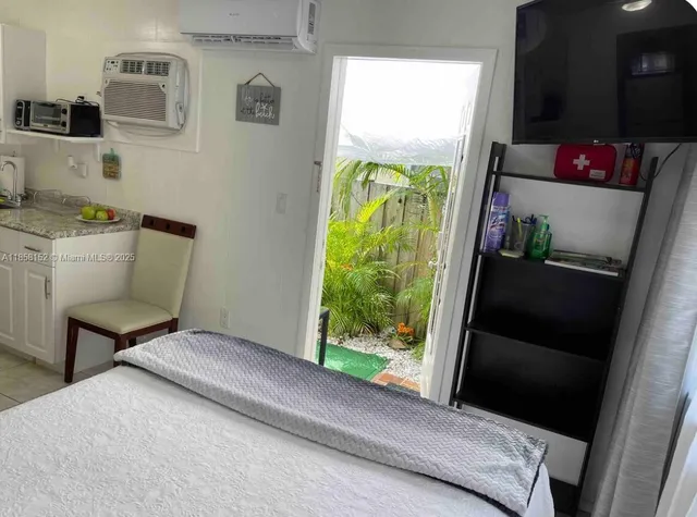 a kitchen with a sink wooden floor and stainless steel appliances