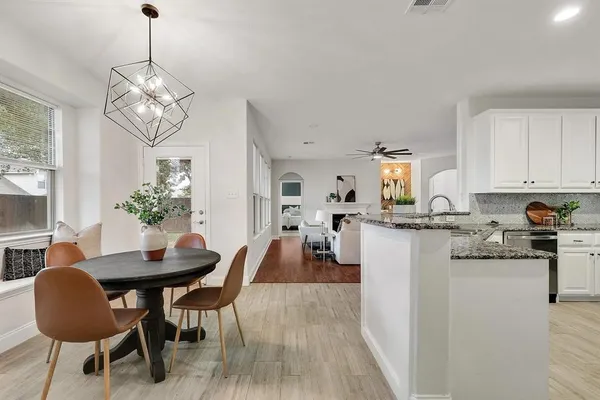 an empty room with chandelier fan
