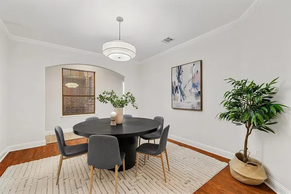 a view of a dining room with furniture and wooden floor