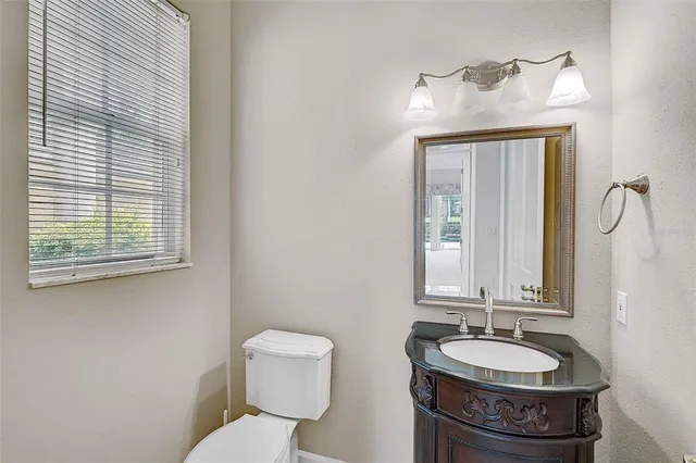 a bathroom with a toilet sink and mirror