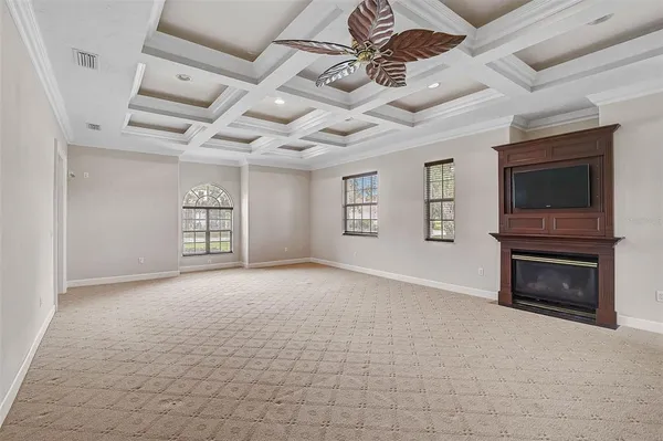 a view of an empty room with a fireplace and a window