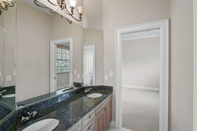 a bathroom with a granite countertop sink a mirror and a shower