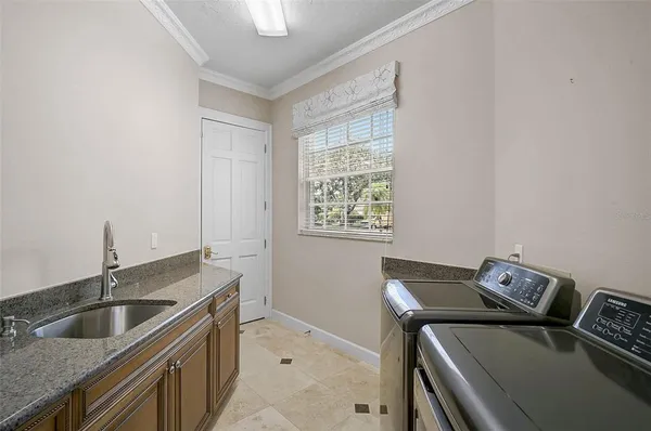 a utility room with a sink dryer and washer