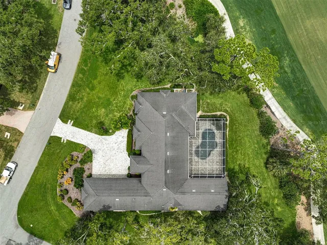 an aerial view of a house with a yard