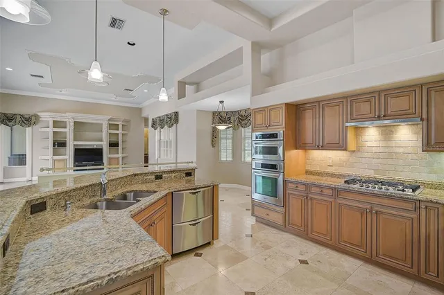 a kitchen with stainless steel appliances granite countertop a stove and a sink