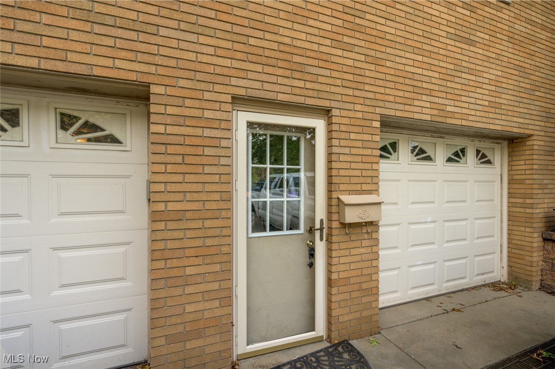 1177 Munroe Falls Kent Road Kent, OH 44240 - Photo 7 of 47 View of exterior entry featuring a garage