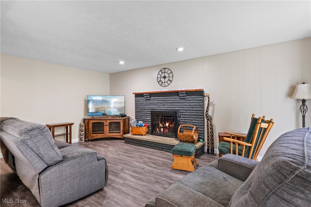 7944 Middle Ridge Road Madison, OH 44057 - Photo 14 of 31 Living area featuring a fireplace, wood finished floors, and recessed lighting