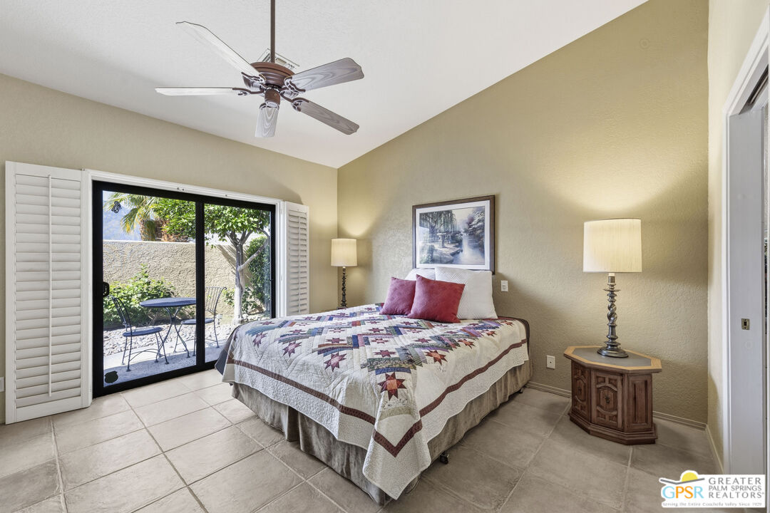 35127 Plumley Road Cathedral City, CA 92234 - Photo 14 of 32 a bedroom with a large bed and a chandelier