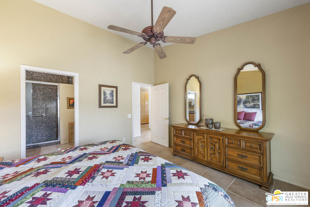 35127 Plumley Road Cathedral City, CA 92234 - Photo 17 of 32 a bedroom with a bed and a dresser in it