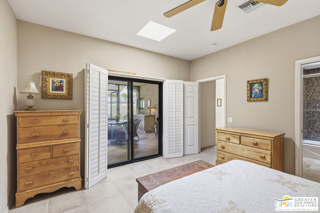 35127 Plumley Road Cathedral City, CA 92234 - Photo 19 of 32 a bedroom with a bed and a dresser