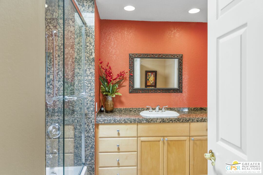 35127 Plumley Road Cathedral City, CA 92234 - Photo 22 of 32 a bathroom with a granite countertop sink and a mirror