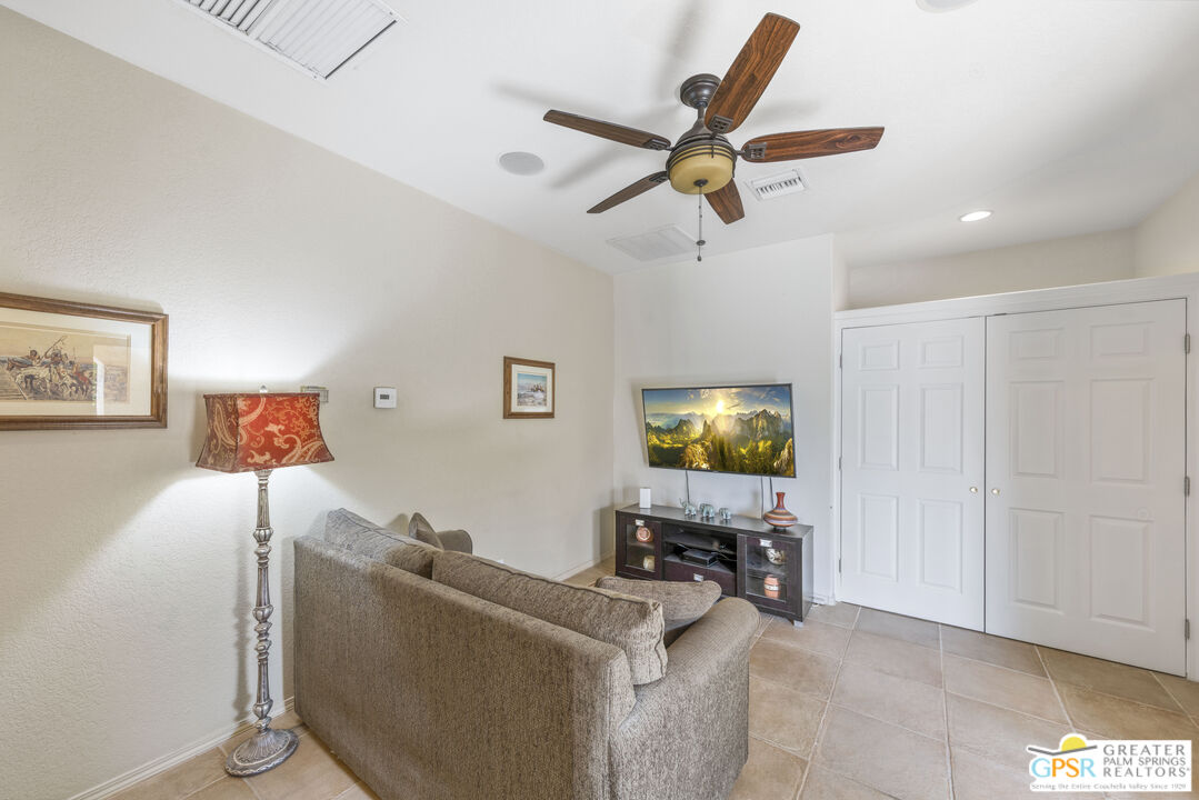35127 Plumley Road Cathedral City, CA 92234 - Photo 23 of 32 a living room with furniture and a flat screen tv
