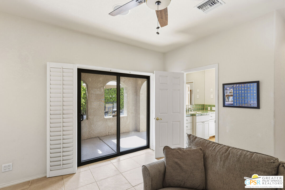 35127 Plumley Road Cathedral City, CA 92234 - Photo 24 of 32 a living room with furniture and a glass door