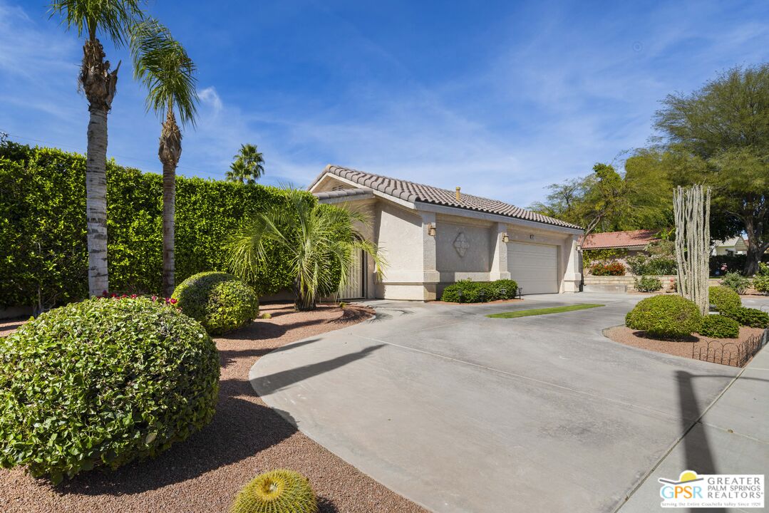 35127 Plumley Road Cathedral City, CA 92234 - Photo 3 of 32 a view of a house with backyard and a garden